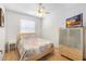 Cozy bedroom with double bed, nightstand and large TV at 5211 Karlsburg Pl, Palm Harbor, FL 34685