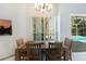Bright dining area with wooden table and chairs, view of pool at 5211 Karlsburg Pl, Palm Harbor, FL 34685