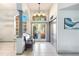 Bright and airy entryway with tiled floors and a charming bench at 5211 Karlsburg Pl, Palm Harbor, FL 34685
