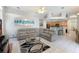 Open living room with sectional sofa, kitchen and dining area visible at 5211 Karlsburg Pl, Palm Harbor, FL 34685