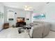 Spacious living room featuring a large sectional sofa and flat-screen TV at 5211 Karlsburg Pl, Palm Harbor, FL 34685