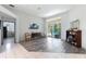 Living room with gray walls, wood-look floors and access to pool at 5211 Karlsburg Pl, Palm Harbor, FL 34685