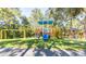 Community playground with playset, swings, and covered picnic area at 5211 Karlsburg Pl, Palm Harbor, FL 34685