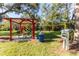 Community playground with covered picnic area and Little Free Library at 5211 Karlsburg Pl, Palm Harbor, FL 34685