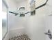 Clean shower with hexagon tile floor and built-in seat at 5211 Karlsburg Pl, Palm Harbor, FL 34685