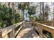 Wooden boardwalk path with railings leads to waterfront views at 5211 Karlsburg Pl, Palm Harbor, FL 34685