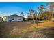 Spacious backyard with grassy area and home view at 5324 Dellbrook Ave, Spring Hill, FL 34608