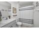 Modern bathroom with gray vanity and shower/tub combo at 5324 Dellbrook Ave, Spring Hill, FL 34608