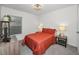 Cozy bedroom with a double bed, nightstands, and window at 5324 Dellbrook Ave, Spring Hill, FL 34608