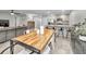 Open concept dining area with kitchen and living room views. Features a wood table and metal chairs at 5324 Dellbrook Ave, Spring Hill, FL 34608