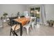 Dining area with wood table, metal chairs, and sliding door access to backyard at 5324 Dellbrook Ave, Spring Hill, FL 34608