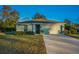 Single-story home with attached garage, landscaping, and a driveway at 5324 Dellbrook Ave, Spring Hill, FL 34608