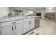 Modern kitchen with stainless steel appliances and granite countertops. Open to dining area at 5324 Dellbrook Ave, Spring Hill, FL 34608