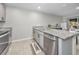 Modern kitchen with stainless steel appliances and granite countertops. Includes an island at 5324 Dellbrook Ave, Spring Hill, FL 34608