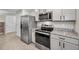 Modern kitchen with stainless steel appliances and granite countertops at 5324 Dellbrook Ave, Spring Hill, FL 34608