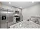 Modern kitchen with stainless steel appliances and granite countertops at 5324 Dellbrook Ave, Spring Hill, FL 34608