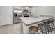 Modern kitchen with stainless steel appliances and granite countertops. Features a breakfast bar at 5324 Dellbrook Ave, Spring Hill, FL 34608