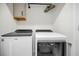 Laundry room with side-by-side Whirlpool washer and dryer at 5324 Dellbrook Ave, Spring Hill, FL 34608