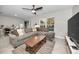 Spacious living room with sectional sofa and large TV at 5324 Dellbrook Ave, Spring Hill, FL 34608