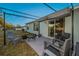 Covered patio with seating area, adjacent to sliding glass door at 5324 Dellbrook Ave, Spring Hill, FL 34608