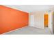 Bedroom with orange accent wall and access to bathroom at 5576 Baywater Dr # 5576, Tampa, FL 33615