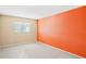 Bright bedroom with orange accent wall and carpet flooring at 5576 Baywater Dr # 5576, Tampa, FL 33615