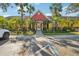 Community clubhouse with inviting entryway, surrounded by palm trees and landscaping at 5576 Baywater Dr # 5576, Tampa, FL 33615