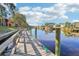 Wooden dock extends over calm water, providing a relaxing waterfront view of the community at 5576 Baywater Dr # 5576, Tampa, FL 33615