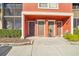 Condo entry with three doors and neatly trimmed bushes at 5576 Baywater Dr # 5576, Tampa, FL 33615