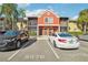 Two-story condo building with parking and lush landscaping at 5576 Baywater Dr # 5576, Tampa, FL 33615