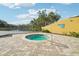 Relaxing circular hot tub surrounded by a brick patio, near a pond at 5576 Baywater Dr # 5576, Tampa, FL 33615