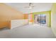 Spacious living room with balcony access and ceiling fan at 5576 Baywater Dr # 5576, Tampa, FL 33615