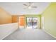 Living room with green and peach walls and balcony access at 5576 Baywater Dr # 5576, Tampa, FL 33615