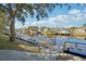 Steps lead down to a wooden deck overlooking a calm canal, boats docked along the waterway at 5576 Baywater Dr # 5576, Tampa, FL 33615