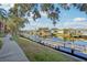 A paved walkway meanders alongside a tranquil canal, offering scenic views of waterfront homes at 5576 Baywater Dr # 5576, Tampa, FL 33615