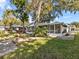 House exterior showcasing a screened porch and lush lawn at 7195 Bethesda Ct, Weeki Wachee, FL 34607