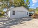 Detached single-car garage with a large driveway at 7195 Bethesda Ct, Weeki Wachee, FL 34607