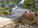 Detached single-car garage with a large driveway at 7195 Bethesda Ct, Weeki Wachee, FL 34607