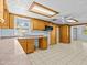 Kitchen with wood cabinets, tile floors, and built-in microwave at 7195 Bethesda Ct, Weeki Wachee, FL 34607