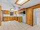 Kitchen featuring wood cabinets, tile floors, and a microwave at 7195 Bethesda Ct, Weeki Wachee, FL 34607
