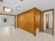 Living area with wood wall paneling and tile flooring at 7195 Bethesda Ct, Weeki Wachee, FL 34607
