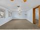Bright living room featuring light blue walls, ceiling fan, and carpet flooring at 7195 Bethesda Ct, Weeki Wachee, FL 34607