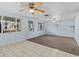 Spacious living room with light blue walls, ceiling fan, and carpet flooring at 7195 Bethesda Ct, Weeki Wachee, FL 34607