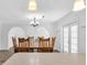 Dining room with hardwood floors and view of the living room at 7218 Box Elder Dr, Port Richey, FL 34668