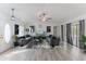 Spacious living room with gray sofas and wood-look floors at 7256 Royal Oak Dr, Spring Hill, FL 34607