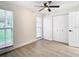 Well-lit bedroom with double door closet and wood-look floors at 7400 Mitchell Ranch Rd, New Port Richey, FL 34655