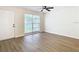 Open living area with wood-look floors and large window at 7400 Mitchell Ranch Rd, New Port Richey, FL 34655