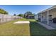 Large backyard with patio, concrete slab, and wood fence at 7745 Jenner Ave, New Port Richey, FL 34655