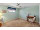 Bedroom with desk and chair, ceiling fan and neutral walls at 7745 Waterford St, New Port Richey, FL 34653