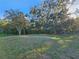 Large backyard with mature trees and grassy area at 8030 Gulf Way, Hudson, FL 34667